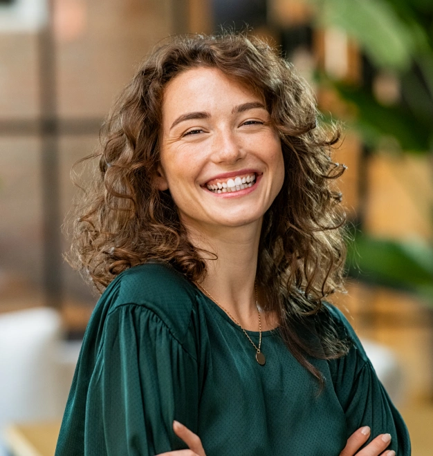 Patient smiling after cosmetic dentistry treatment with bright, natural-looking teeth.