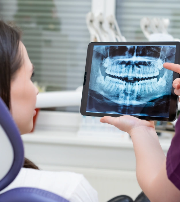 Dentist showing x ray to a patient