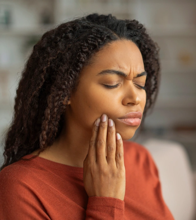 Woman holding her jaw in pain