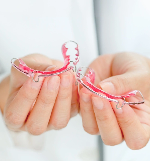 Clear retainers held in hands